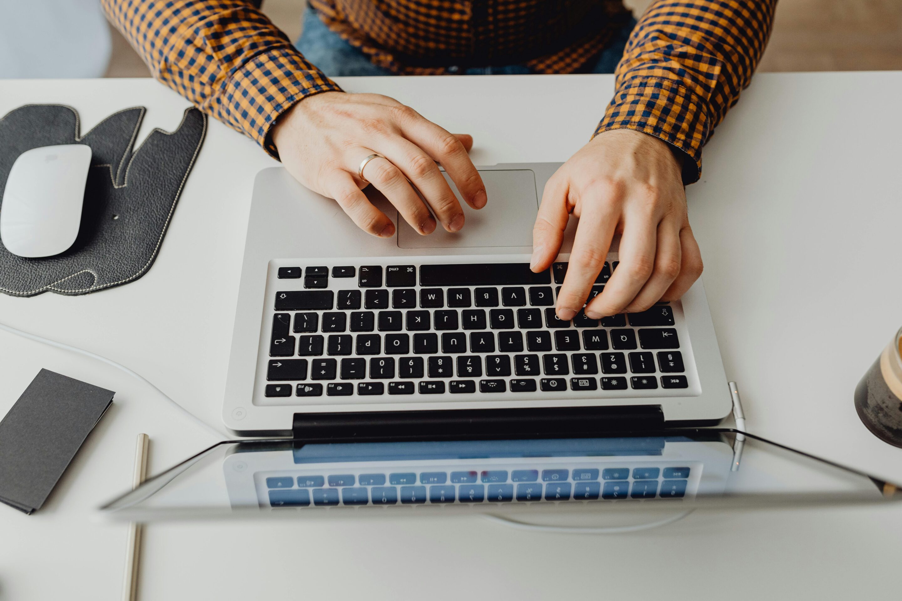 Professional working on a laptop representing remote workforce productivity and global hiring opportunities showing it's easy to hire globally now.